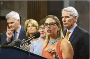  ?? J. SCOTT APPLEWHITE / AP ?? Sen. Kyrsten Sinema, D-Ariz. (center), joined from left by Sen. Bill Cassidy, R-La., Sen. Lisa Murkowski, R-Alaska, Sen. Susan Collins, R-Maine, and Sen. Rob Portman, R-Ohio, speaks on the infrastruc­ture plan.