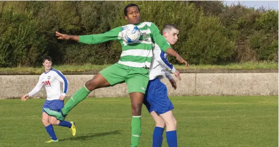  ??  ?? Alieo Memah Sesay of MCR in action with Merville’s Garry McCartney. Pic: Donal Hackett.