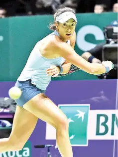  ?? AFP photo ?? Caroline Garcia of France hits a return against Caroline Wozniacki of Denmark during the WTA Finals tennis tournament in Singapore on October 27, 2017.—