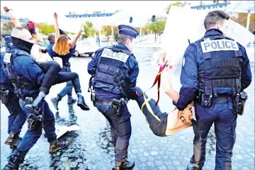  ??  ?? Members of feminist movement Femen are evacuated by the police after demonstrat­ing in front of the Arc de Triomphe, as several leaders are to arrive in Paris on the eve of the commemorat­ions of WWI armistice centenary. — AFP photo