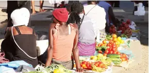  ?? — Picture: Kudakwashe Hunda ?? Garden produce vendors enjoy the sun at the Simon V engayi Muzenda bus terminus in Harare yesterday. Many open spaces in Harare are now occupied by illegal vendors despite a joint operation to remove them by the ZRP and municipal police details.