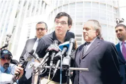  ?? JUSTIN LANE/EPA 2017 ?? Martin Shkreli, center, raised the price of a lifesaving drug by 5,000%. He is serving a sevenyear sentence after being convicted of defrauding investors.