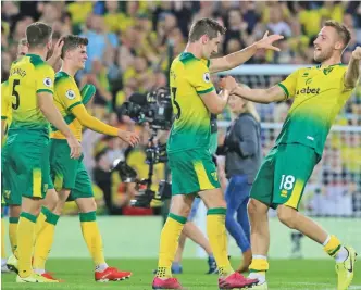  ?? — AFP ?? Norwich City players celebrate their 3-2 win over Manchester City in their English Premier League match at Carrow Road in Norwich on Saturday.