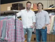  ?? SETH WENIG — THE ASSOCIATED PRESS ?? Untuckit founder Chris Riccobono, left, and CEO Aaron Sanandres pose for a picture in one of their stores in New York. When Untuckit launched six years ago, it was hard to find a men’s shirt that could be worn untucked and didn’t look sloppy. Now the company is facing competitio­n from the Gap, J. Crew and other stores that have started to sell shortened shirts.