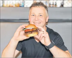  ?? TERRENCE MCEACHERN/THE GUARDIAN ?? Richard Court, left, owner of the Pilot House, holds the restaurant’s winning entry in this year’s P.E.I. Burger Love contest – the One-Eyed Jack burger.