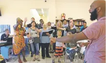  ?? URIEL J. GARCIA/THE NEW MEXICAN ?? Brandon Boyd leads the Santa Fe Desert Chorale on Wednesday as the group performs for an audience at the Interfaith Community Shelter at Pete’s Place.