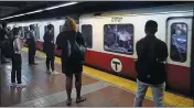  ?? CHARLES KRUPA — THE ASSOCIATED PRESS ?? Commuters wait as a train full of passengers arrives at the South Station Red Line subway stop, on July 13 in Boston.