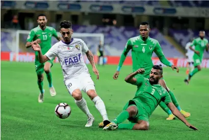  ?? AGL ?? emirates club’s Ahmed Al Marzooqi makes a sliding tackle to thwart Al Ain’s Ruben Ribeiro during their AGl match on tuesday. —