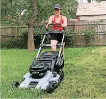  ?? [PHOTO PROVIDED BY JOHN PEDERSON] ?? At her new home, the author’s daughter test drives the next generation of lithium-battery-powered mowers, which are greener, cleaner and quieter.