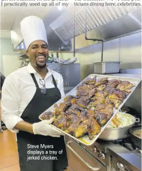  ?? ?? Steve Myers displays a tray of jerked chicken.