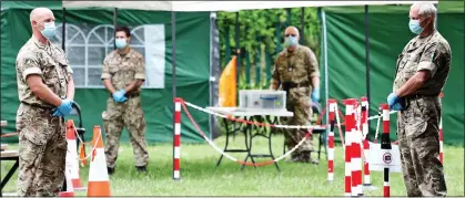  ??  ?? FIGHT BACK: Soldiers from the 7 Regiment Royal Logistics Corps at a testing station at Leicester’s Spinney Hill Park