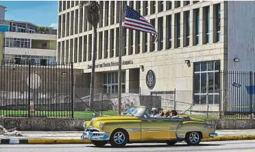  ?? — AFP ?? Taking precaution­s: A car passing by the US embassy in Havana where most of its diplomats have been withdrawn over an ‘illness’.