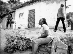  ??  ?? Women mourn the death of a family member following a landslide in Kinshasa. — AFP photo