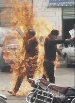  ??  ?? Two Tibetans are engulfed in flames as they hold independen­ce flags in an act of self-immolation to protest against Chinese rule in Qinghai province on Wednesday. The Tibetan Youth Congress released a graphic video. One man died and another was...