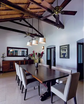  ??  ?? Traditiona­l Balinese dining table (above); louvered shutters (below)