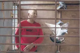  ??  ?? Huanan market vendor Jiang Dafa tends to his pigeons at home in Wuhan in October. China’s search for the COVID-19 virus started in the Huanan Seafood market in Wuhan, a sprawling, low-slung complex where many of the first human coronaviru­s cases were detected.