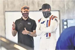  ?? INDYCAR SERIES ?? Seven- time NASCAR Cup Series champion Jimmie Johnson, right, tested an Indy car in March with the help of veteran Scott Dixon.