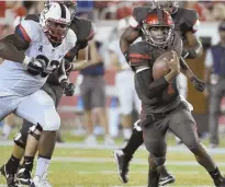  ?? AP PHOTO ?? ONE TO WATCH: Houston quarterbac­k Greg Ward Jr. (1) runs past UConn’s Folorunso Fatukasi during last night’s American Athletic Conference game.