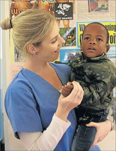  ?? Picture: MALIBONGWE DAYIMANI ?? SENSELESS THEFT: East London audiologis­t Catherine Richter with little Inothando Qalinto, 2, who could not have his cochlear implant connected yesterday and hear sound for the first time because thieves stole programmin­g cables and computers necessary...