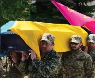  ?? ?? Soldiers carry a coffin of soldier Ruslan Borovyk, killed by Russian troops, at his funeral at St Michael cathedral in Kyiv