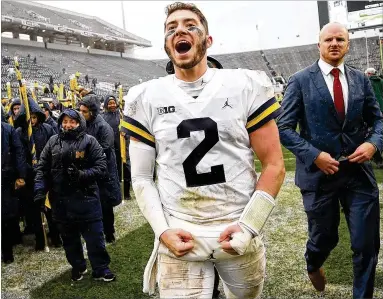  ?? GREGORY SHAMUS / GETTY IMAGES ?? Michigan quarterbac­k Shea Patterson leaves the field in East Lansing, Mich., after his Wolverines defeated their rivals Michigan State 21-7 on Oct. 20.