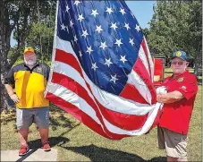  ?? Westside Eagle Observer/RANDY MOLL ?? Jim Wilbanks, adjutant, and Joe Zelk, second vice commander of American Legion Post 159, get ready to raise the flag at the July 4 Freedom Festival at Gentry City Park.