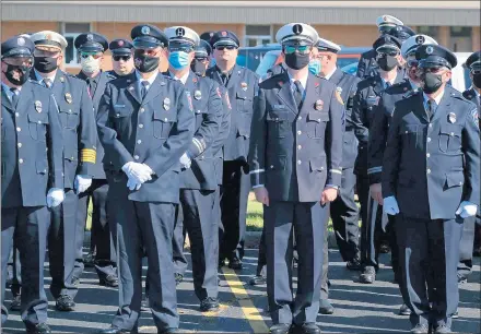  ??  ?? .
Firefighte­rs from various suburbs stand outside St. John Catholic Church in Glenwood for the funeral of South Holland firefighte­r Dylan Cunningham.