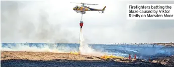  ?? ?? Firefighte­rs batting the blaze caused by Viktor Riedly on Marsden Moor