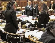  ?? BOB ANDRES / BANDRES@AJC.COM ?? Reps. Park Cannon (left), D-Atlanta, and Pam Stephenson, D-Decatur, brought coat hangers to the House on Thursday to show opposition to HB 481.