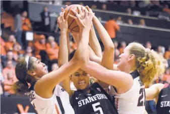  ?? Andy Cripe / Associated Press ?? Oregon State’s Taya Corosdale (left) and Marie Gulich battle Stanford’s Kaylee Johnson for a first-half rebound. Stanford had 17 offensive rebounds to offset poor long-distance shooting.