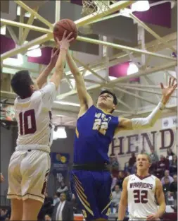  ?? PETE BANNAN — DIGITAL FIRST MEDIA ?? West Chester Henderson’s John Briglia (13) and Downingtow­nn West’s Cam McCole battle for a rebound under West’s basket in the first quarter Thursday.