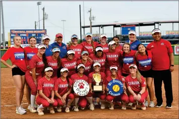  ?? Photo Credit Courtesy of Lyndel Moody ?? The No.1 Coahoma Bulldogett­es pose with their Class 3A Bi-district championsh­ip trophy after beating Ingram Moore Thursday afternoon in the opening round of the playoffs. Final score of the game was 17-0 Coahoma.