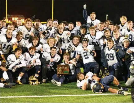  ?? PAUL DICICCO — THE NEWS-HERALD ?? Kirtland players celebrate their 20-14 win over Mogadore on Nov. 16 in a Division VI regional final at Aurora High School.