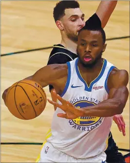  ?? JONATHAN DANIEL — GETTY IMAGES ?? The Warriors’ Andrew Wiggins passes under pressure from the Bulls’ Zach LaVine on Sunday. Wiggins had 17of his 27points in the final quarter against the Pistons on Tuesday.