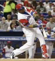  ?? LYNNE SLADKY/THE ASSOCIATED PRESS ?? Nelson Cruz doubles for the Dominican Republic, one of six hits off Canada’s Ryan Dempster in the second inning.