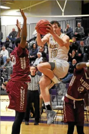  ?? ANNE NEBORAK-DIGITAL FIRST MEDIA ?? Jackson Hyland makes a basket during the game. As Lock Haven team members Ra’eese Hunt and Amir Hinton are beside him.