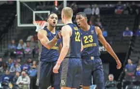  ?? WENDELL CRUZ / USA TODAY SPORTS ?? Marquette’s Theo John (from left), Joey Hauser and Jamal Cain regroup during a timeout in the second half Wednesday night.