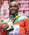  ??  ?? Gold medalist Anderson Peters, of Grenada shows off his medal at the World Athletics Championsh­ips
in Doha, Qatar, on Oct. 6. (AP)