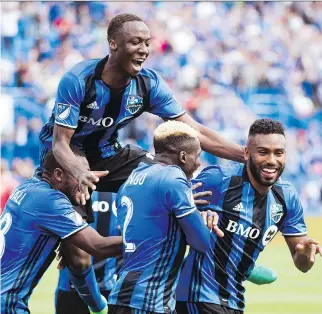  ?? GRAHAM HUGHES/THE CANADIAN PRESS VIA AP ?? Montreal Impact’s Anthony Jackson-Hamel, right, celebrates with teammates after scoring the game-winning goal against Atlanta United in Montreal on Saturday.