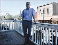  ?? Susan Holland/Westside Eagle Observer ?? Huett poses on the balcony of his dental practice at 111 Main Street S.E. in Gravette. Huett, a Tontitown native, enjoys the view and says he is happy to return to the area after attending dental school in Tennessee and operating a practice there for a couple of years. He offers a full range of dental services and is looking forward to meeting the needs of patients in Northwest Arkansas.