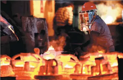  ?? LI KE / FOR CHINA DAILY ?? A worker forges metal products at Zixing Huagang Investment Casting Co, a producer of valve parts and pump parts, among other things, based in Zixing, Hunan province.