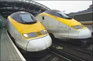  ?? John Davenport / San Antonio Express-News ?? Electric locomotive­s for the Eurostar train that travels under the chunnel to Paris, France, sit idle at Waterloo station in London, England.