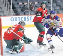  ?? TIM KROCHAK • THE CHRONICLE HERALD ?? Goalie Brady James and defenceman Cameron Whynot defend the Halifax Mooseheads net against Moncton Wildcats forward Philippe Daoust during a QMJHL game at the Scotiabank Centre earlier this season.