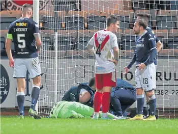  ?? ?? OUT OF CONTENTION: Top – Goalkeeper Ian Lawlor will miss Dundee’s clash with Inverness Caley Thistle. Above – Lawlor receives treatment after his head injury.