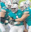  ?? JOHN MCCALL | SOUTH FLORIDA SUN SENTINEL ?? Dolphins quarterbac­k Tua Tagovailoa celebrates after scoring against the Patriots .