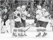  ?? JASON BEHNKEN/AP ?? The Panthers celebrate a second-period goal against the Lightning on Saturday in Tampa, Fla.