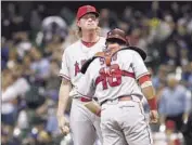  ?? Dylan Buell Getty I mages ?? JERED WEAVER and Geovany Soto chat after the pitcher gives up a two- run double in the f if th inning.