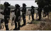  ??  ?? Mexican National Guardsmen stand guard along the Mexican side of the bank of the Suchiate River near Ciudad Hidalgo, Mexico, on Tuesday.