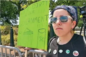  ?? (AP Photo/Jacquelyn Martin) ?? Erin Tinerella, of Chicago, who is in Washington for the summer at an internship, protests against climate change after the Supreme Court’s EPA decision, Thursday, June 30, 2022, at the Supreme Court in Washington.