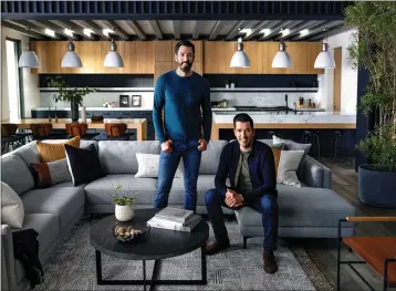  ?? COURTESY OF LIVING SPACES ?? “Property Brothers” hosts Drew Scott, left, and his brother, Jonathan Scott, in a room furnished with pieces from their new furniture line. The Drew & Jonathan for Living Spaces collection debuted this week.